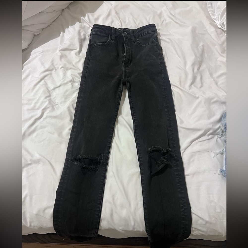 Black American Eagle jeans with rips in the knees.